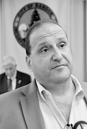 City Councilor Joe Baldacci at a Bangor city council meeting being interviewed by the press. Photo by Ramona du Houx