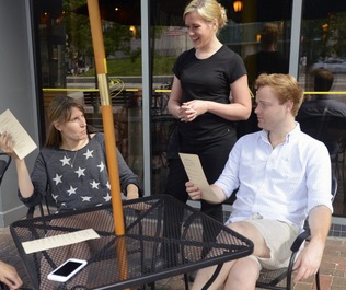 Averil Burner, a server at David’s in Portland, waits on customers. Portland city councilors will consider ways to give tipped employees a higher minimum wage without putting an extra burden on restaurant owners. Shawn Patrick Ouellette/Staff Photographer